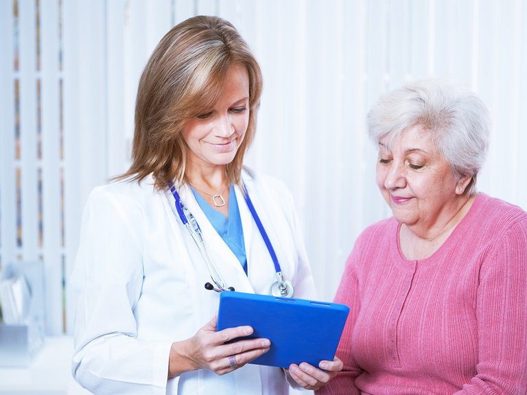 Physician and patient looking at tablet